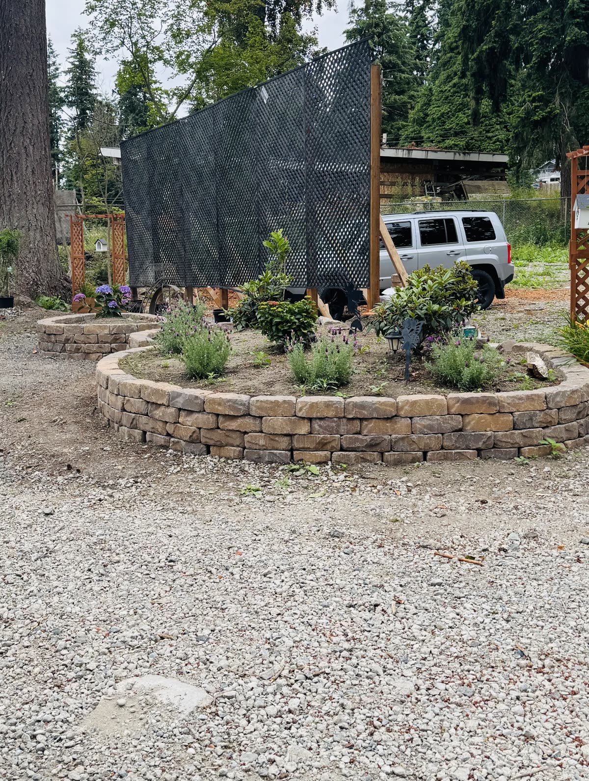 Small curved block retaining wall and planted garden bed during work