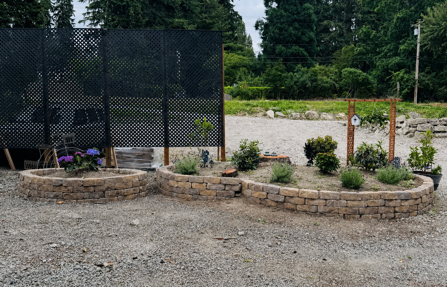 Curved block retaining wall and landscaped bed during work